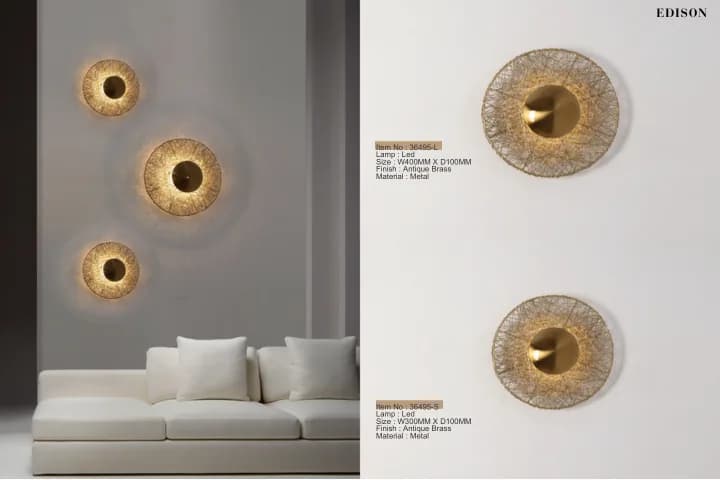 Textured brass disc wall lights over a sofa