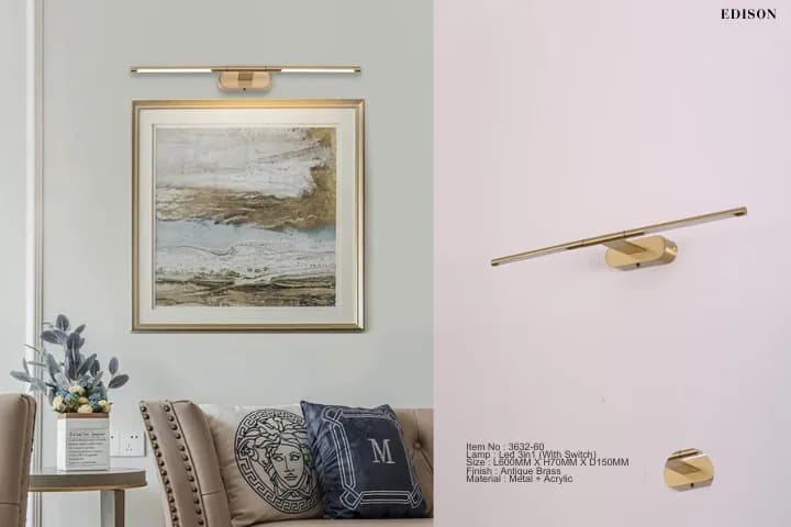 A brass picture light above a framed painting