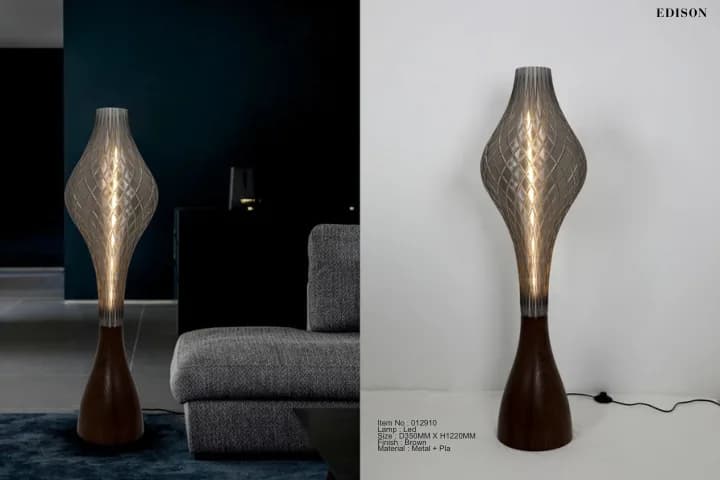 A sculpted floor lamp in a dark living room